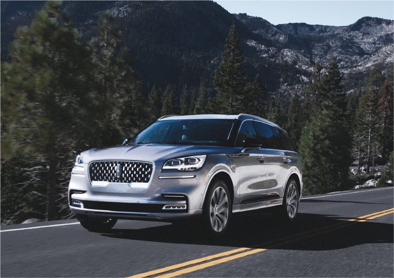 A 2023 Lincoln Aviator® Grand Touring SUV being driven on a winding road to demonstrate the capabilities of all-wheel drive | All Star Lincoln in Prairieville LA