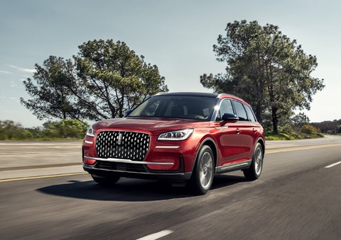 A 2023 Lincoln Corsair® SUV is shown being driven on a country road. | All Star Lincoln in Prairieville LA