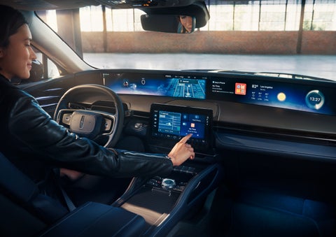 The driver of a 2024 Lincoln Nautilus® SUV interacts with the center touchscreen. | All Star Lincoln in Prairieville LA