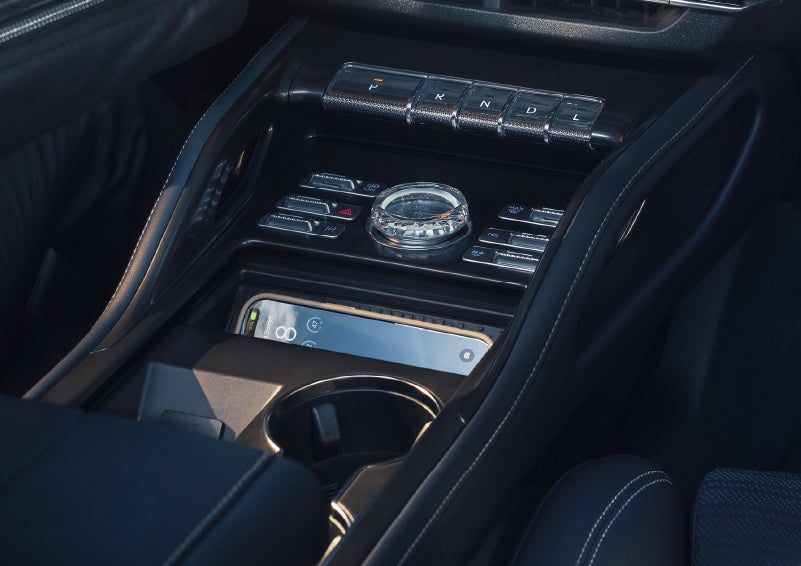 A smartphone is shown charging in the wireless charging pad. | All Star Lincoln in Prairieville LA